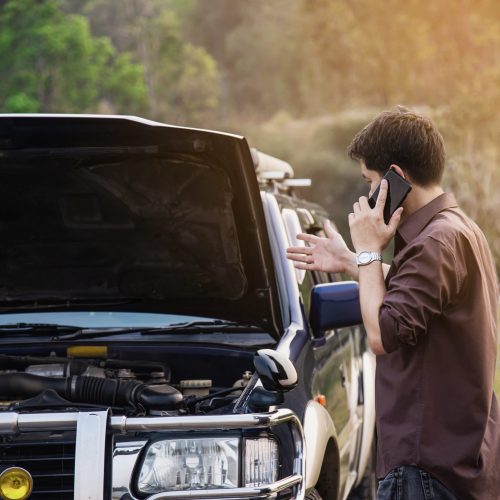 man-try-fix-car-engine-problem-local-road